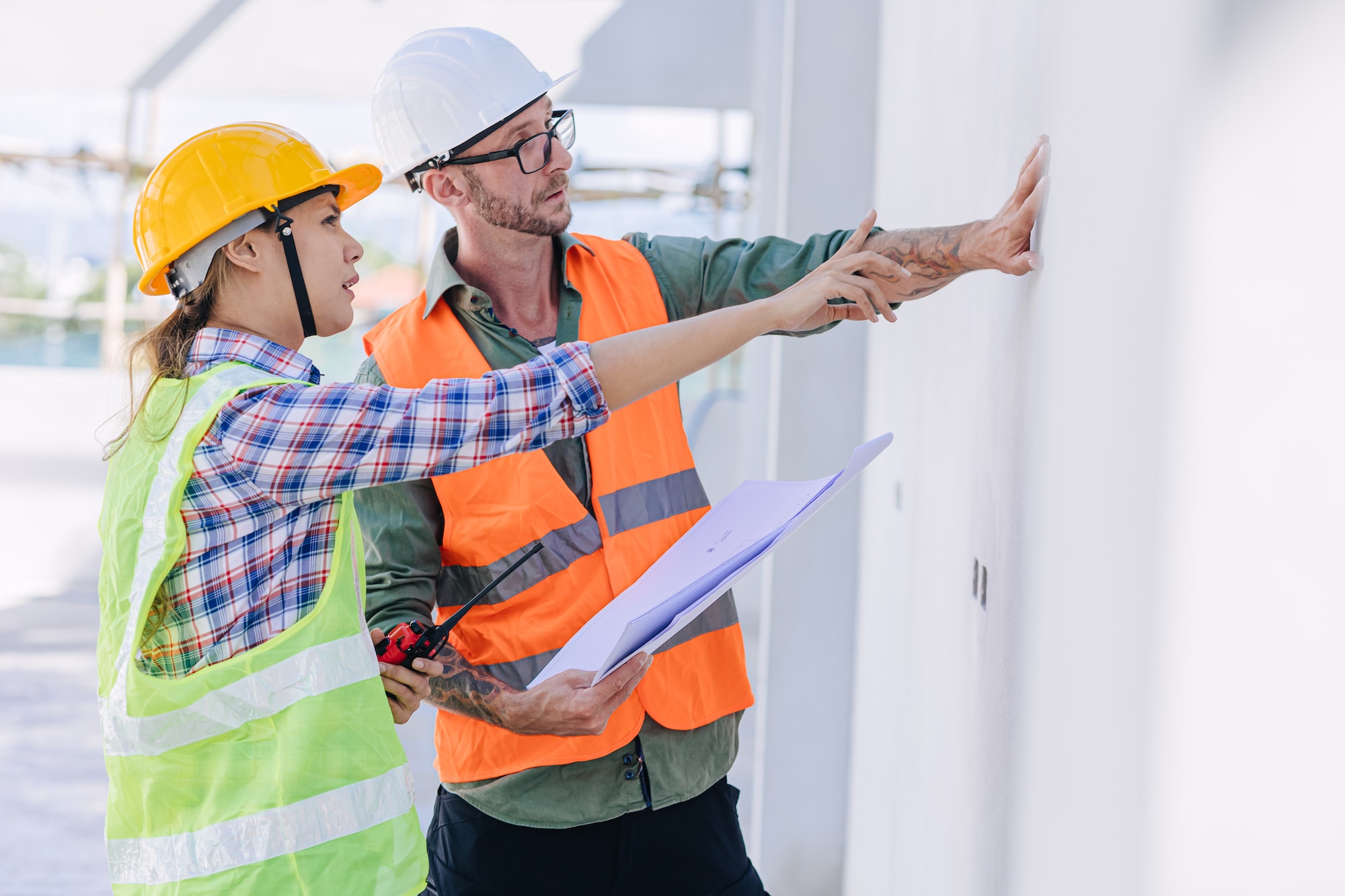 Engineer builder team working at construction site checking build quality wall concrete plastering